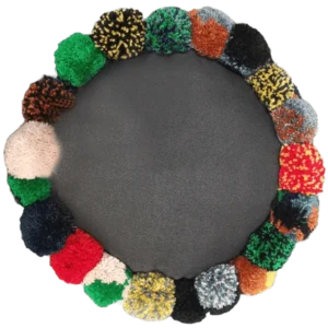 Colourful pom-pom wreath on grey background.