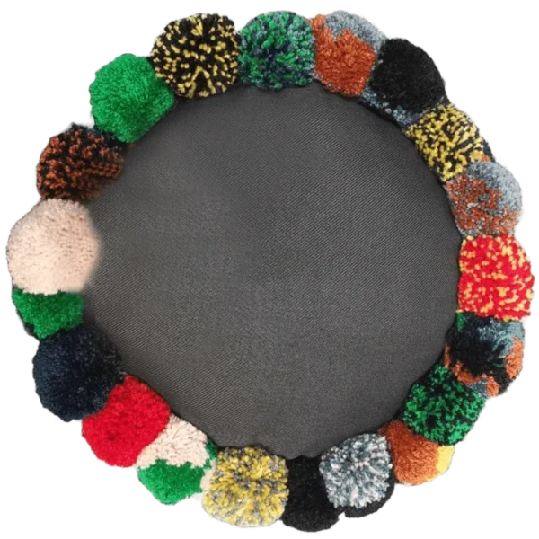 Colourful pom-pom wreath on grey background.