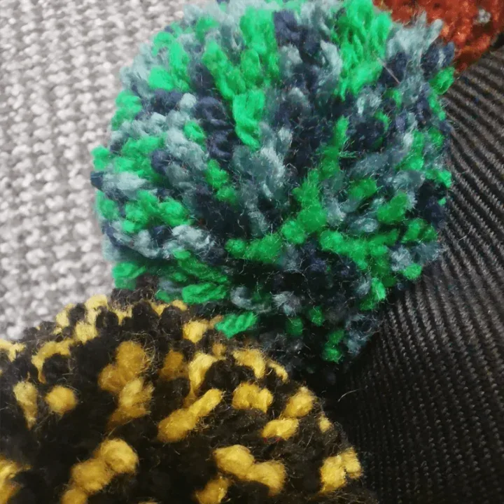 Close-up of colorful yarn pom-poms.