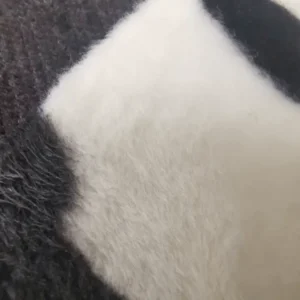 Close-up of black and white animal fur texture.