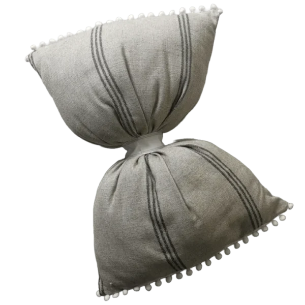 Striped cushions with pom-pom trim on striped background.