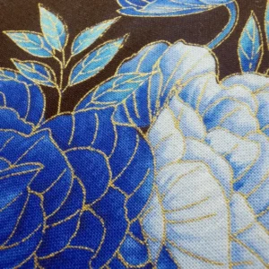 Blue floral fabric texture with gold embroidery.