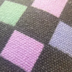 Colourful knitted patchwork texture.