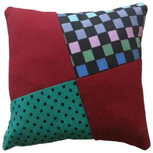 Patchwork cushion with various patterns and colors.