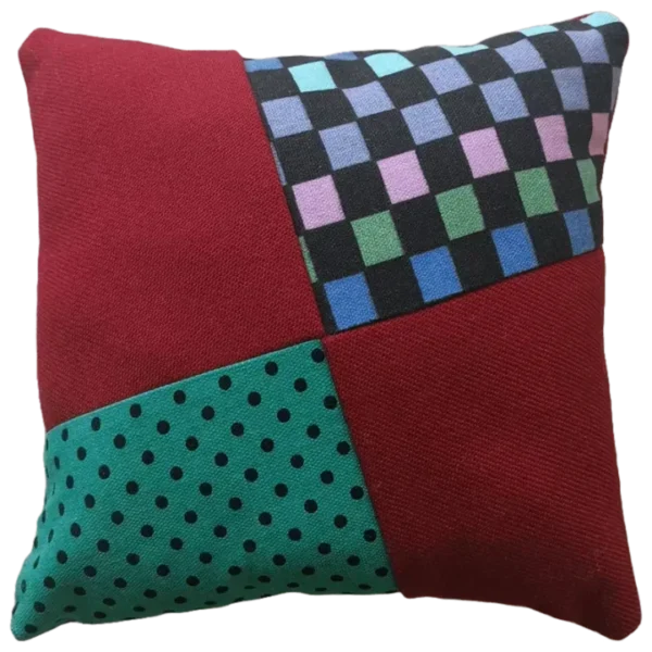 Patchwork cushion with various patterns and colors.