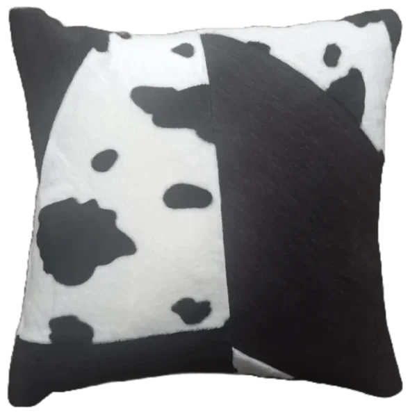 Cow pattern decorative cushion on black background.