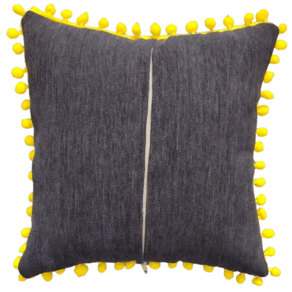 Grey cushion with yellow pom-pom trim.