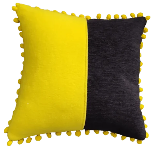 Yellow and black decorative cushions with pom-pom edges.