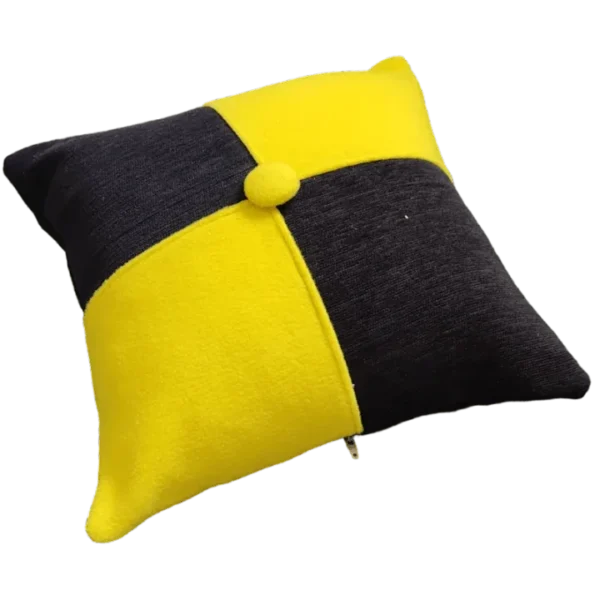 Yellow and black decorative cushion on black background.