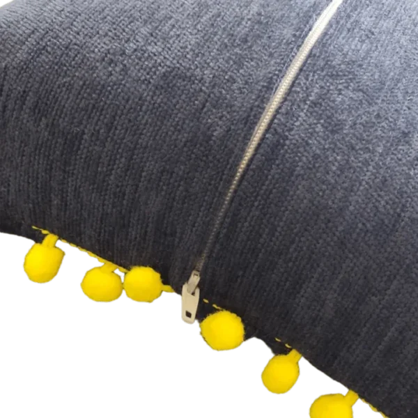 Textured fabric with zipper and yellow pompom trim.
