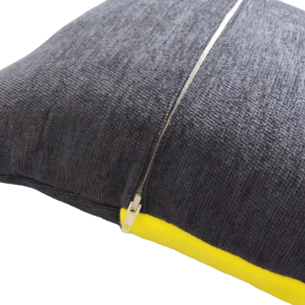 Grey cushion with yellow trim and zipper.